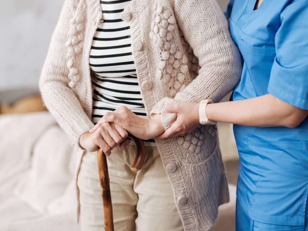 Nurse Helping An Elderly Lady